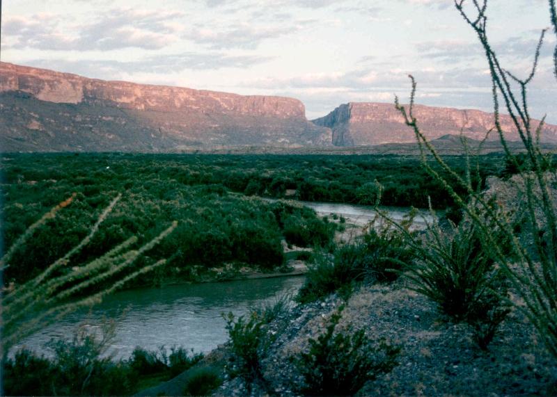 Rio Grande emerges from a canyon in the bakcground (Santa Elena Canyon) and meanders across a plain in the foreground